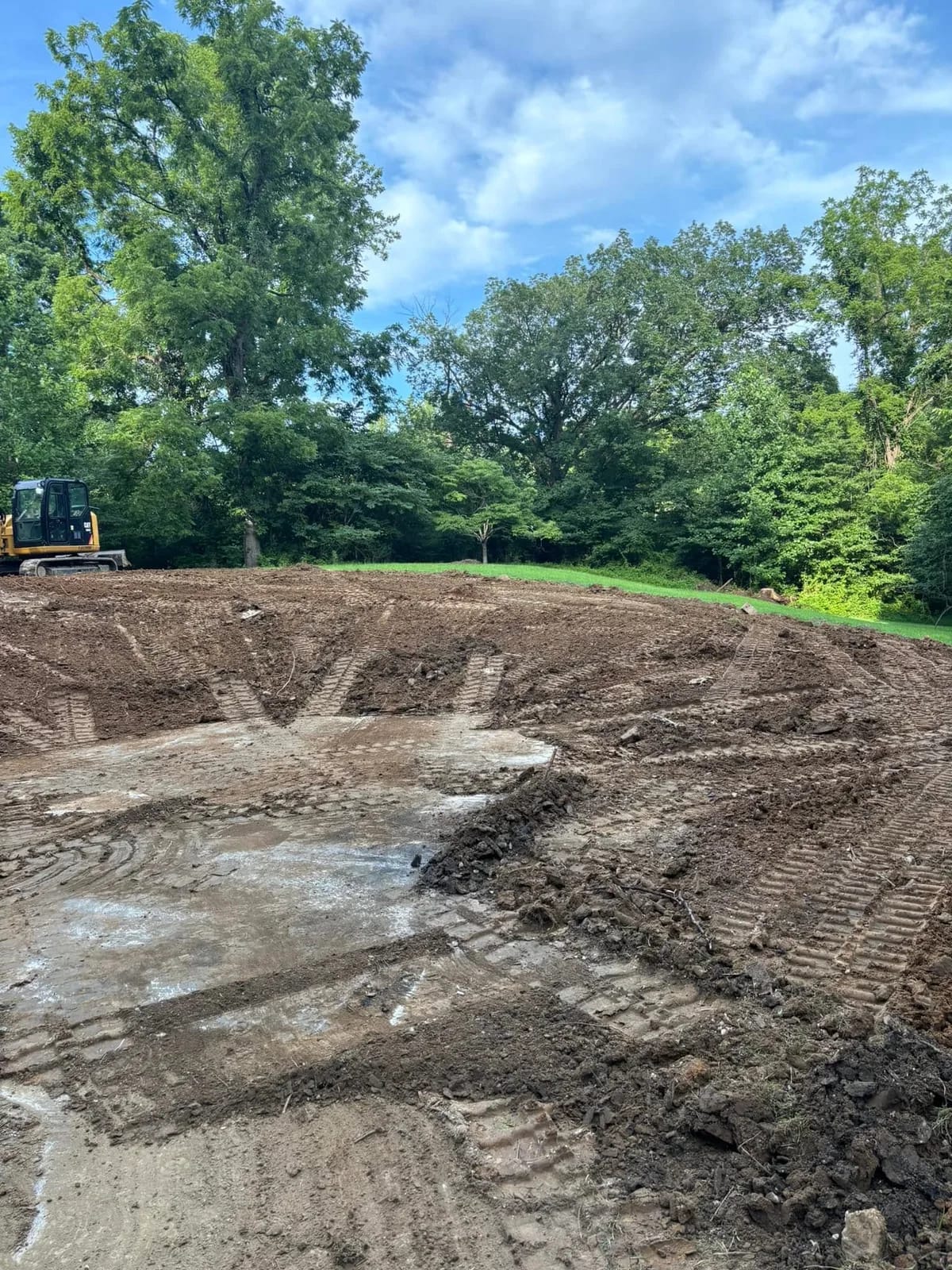 Dozer shaping the bottom of a newly dug pond basin