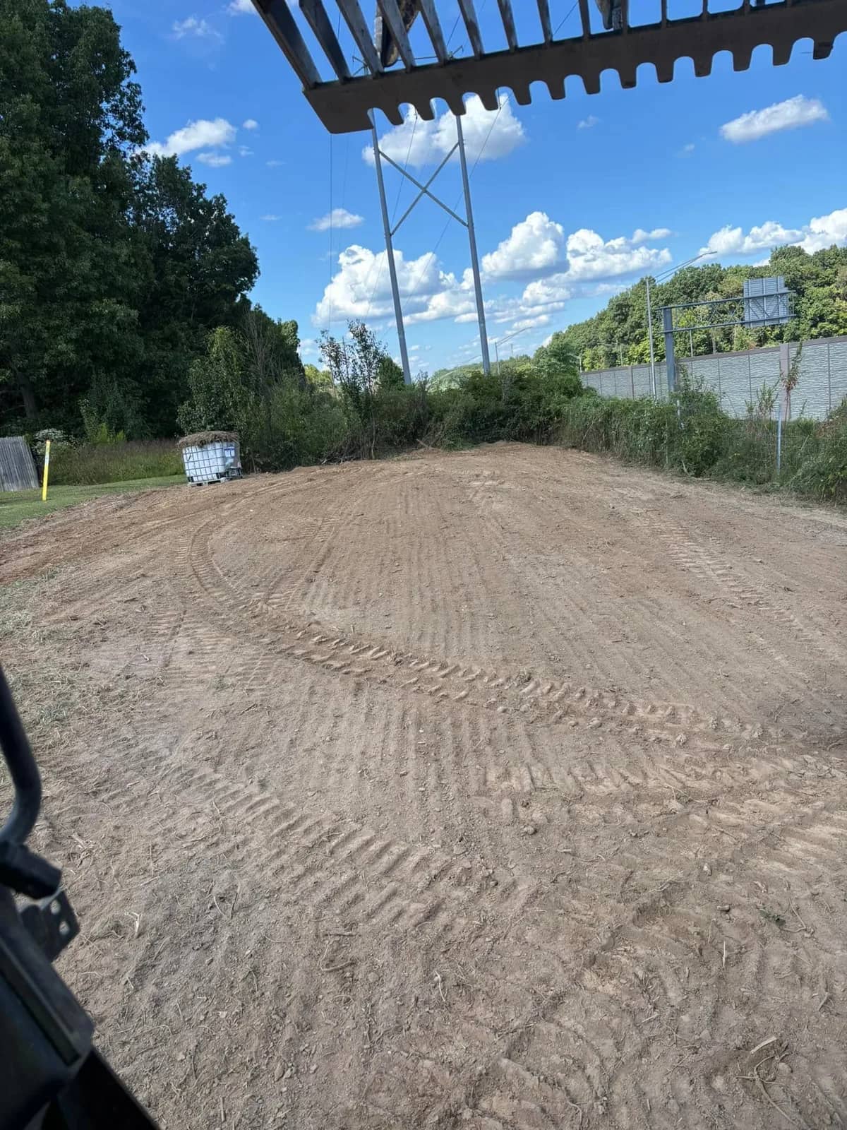 Graded dirt area seen from the excavator cab